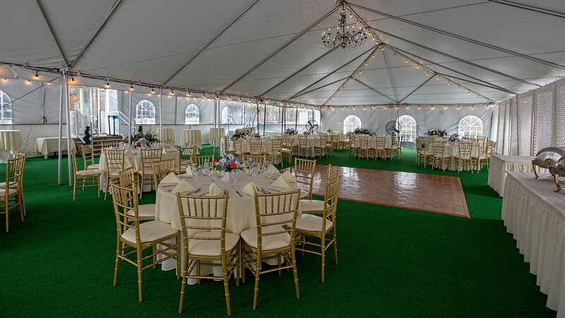 Outdoor banquet party with dance floor and set tables