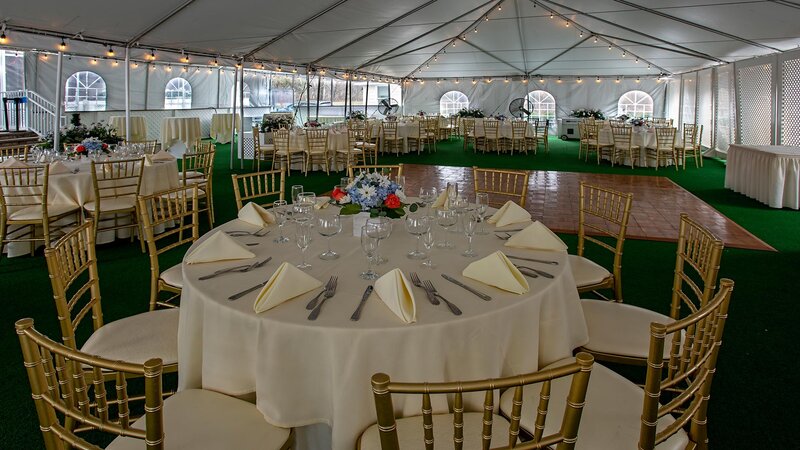 Outdoor banquet area with many set tables